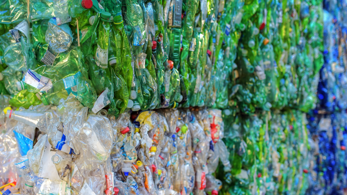 Baled plastic bottles stacked for recycling in Europe’s waste stream.