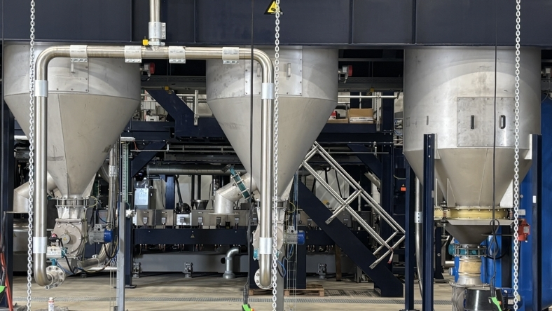 Industrial polymer processing equipment with large hoppers and piping