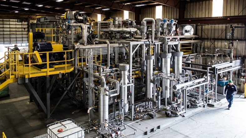 Industrial chemical recycling facility with processing equipment and piping