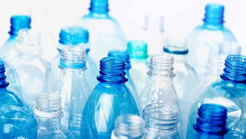 Assorted clear and blue plastic bottles without caps